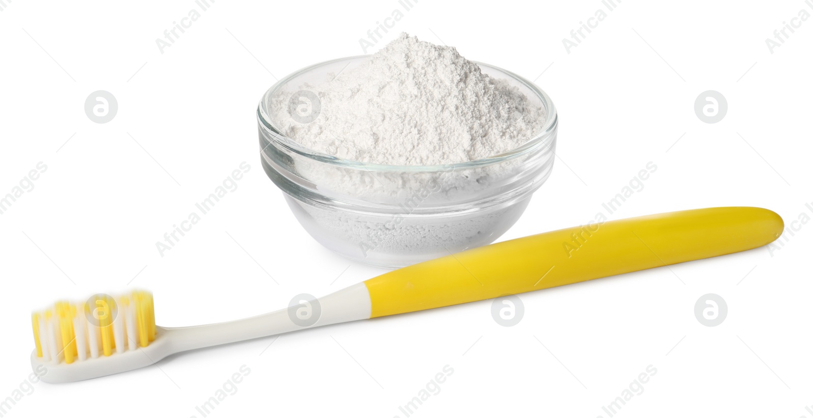 Photo of Glass bowl of tooth powder and brush on white background