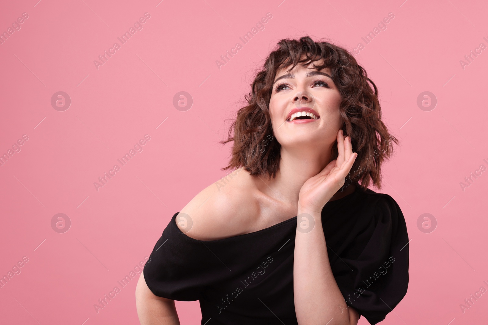 Photo of Portrait of beautiful young woman with wavy hairstyle on pink background. Space for text