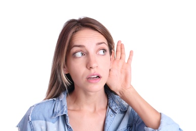 Young woman with hearing problem on white background