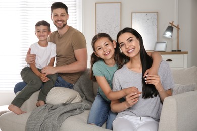 Portrait of happy family in living room. Adoption concept