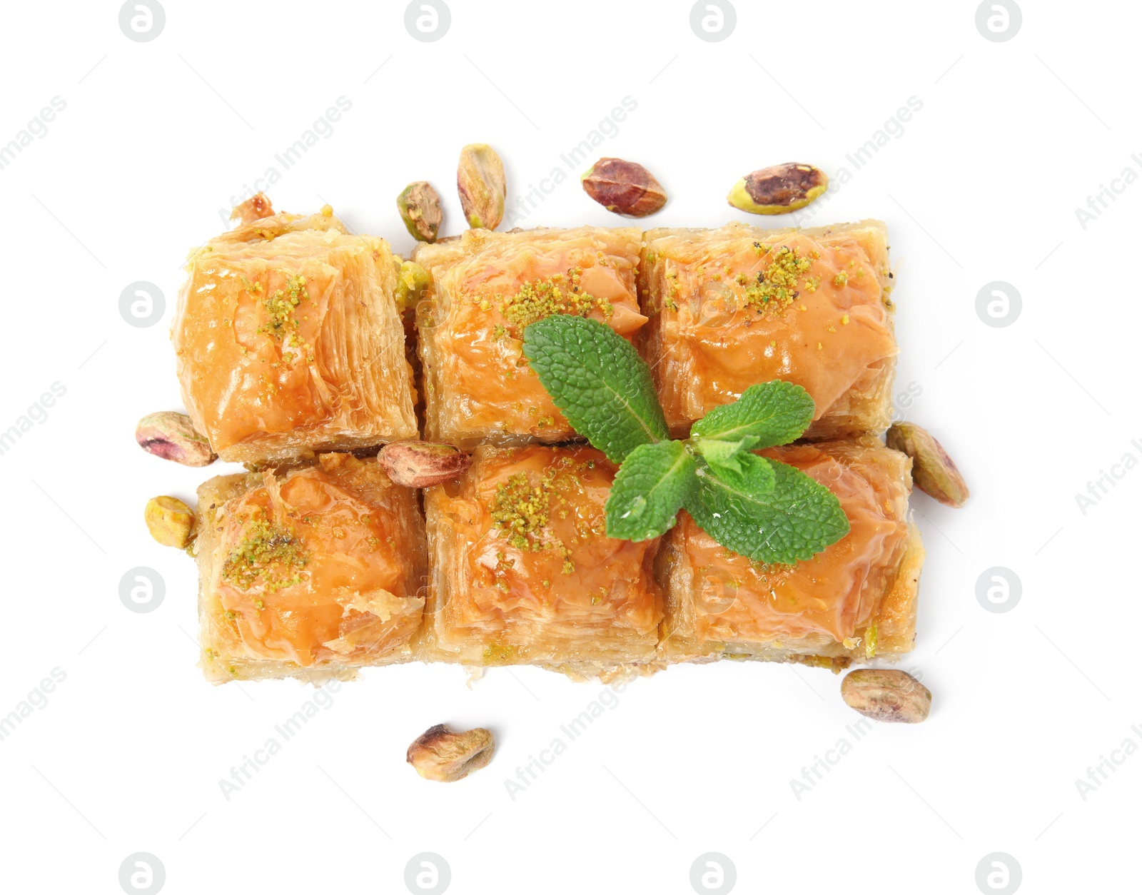 Photo of Delicious baklava with pistachios, mint and scattered nuts on white background, top view