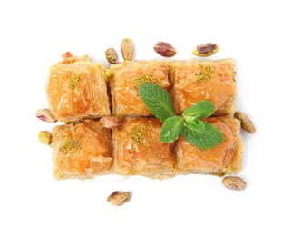 Photo of Delicious baklava with pistachios, mint and scattered nuts on white background, top view