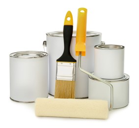 Paint cans, brush and roller on white background