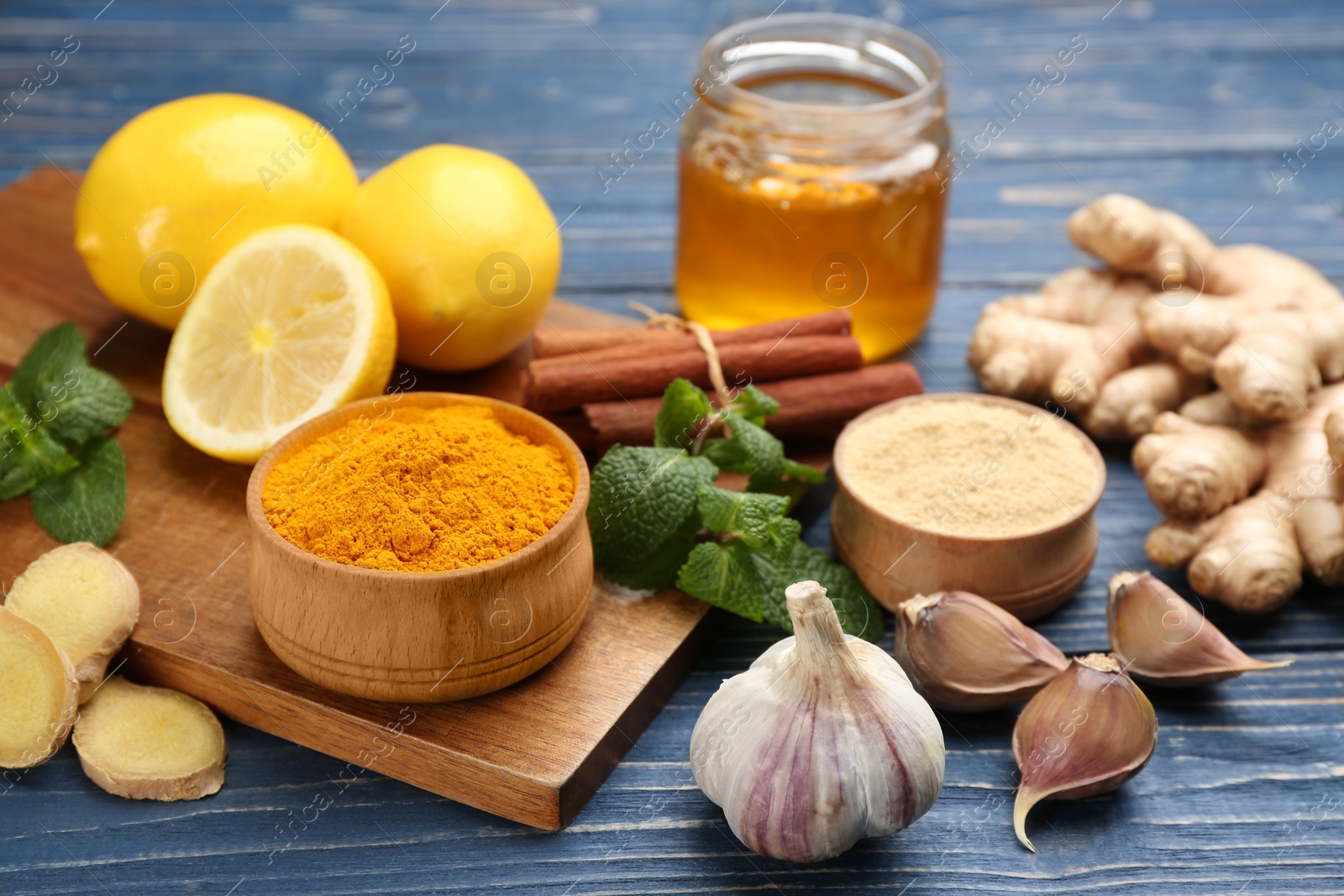 Photo of Different fresh products on blue wooden table. Natural antibiotics