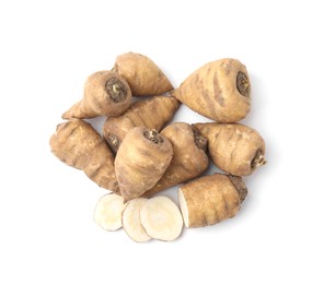 Photo of Whole and cut turnip rooted chervil tubers isolated on white, top view