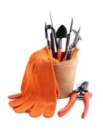 Photo of Pair of gloves and gardening tools on white background