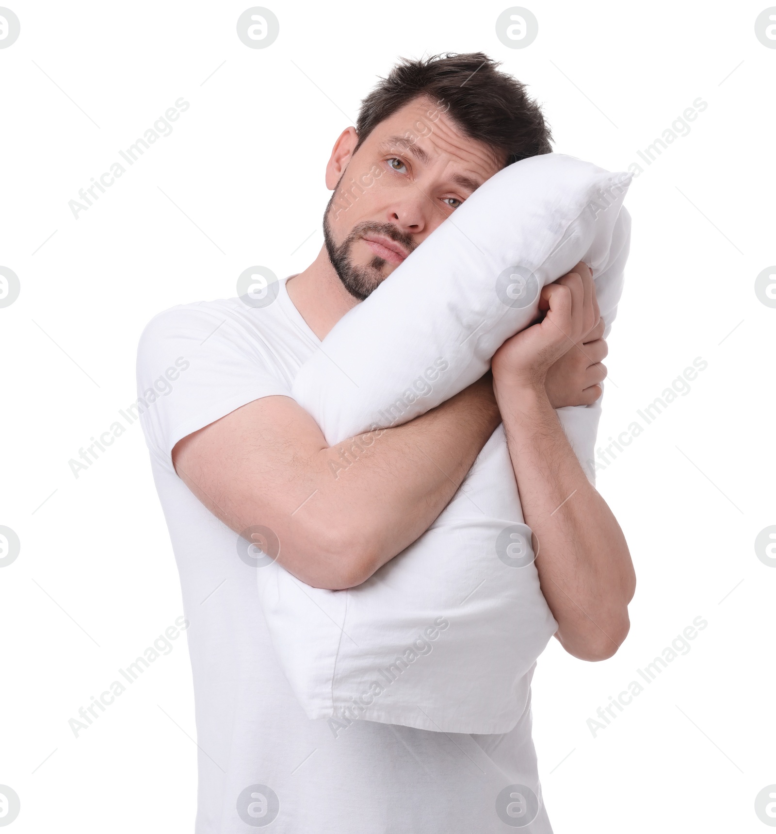 Photo of Tired man with pillow on white background. Insomnia problem