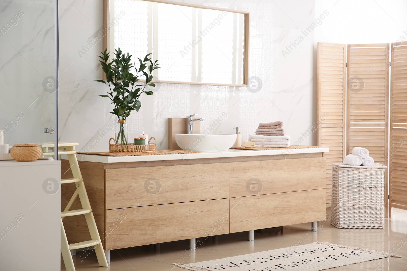 Photo of Modern bathroom interior with stylish mirror and vessel sink