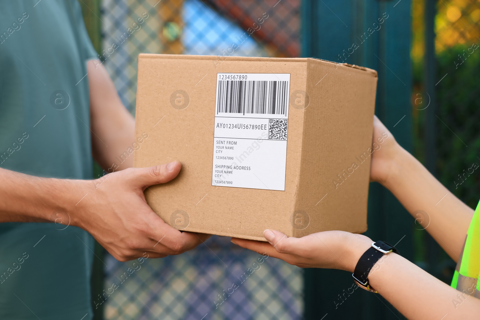 Photo of Man receiving parcel from courier outdoors, closeup