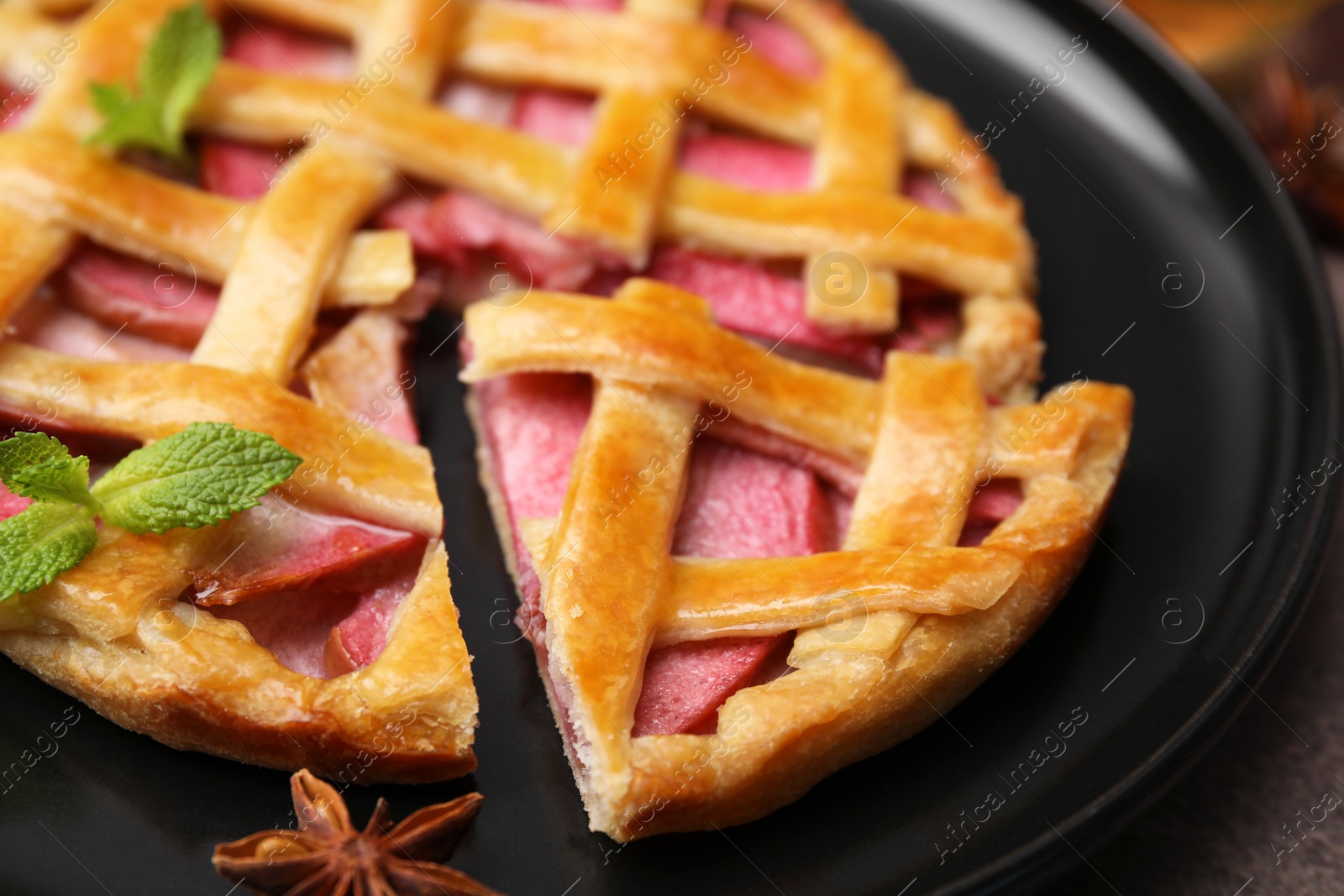 Photo of Delicious apple pie with mint on table, closeup