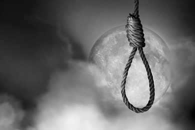 Image of Rope noose with knot outdoors on full moon night