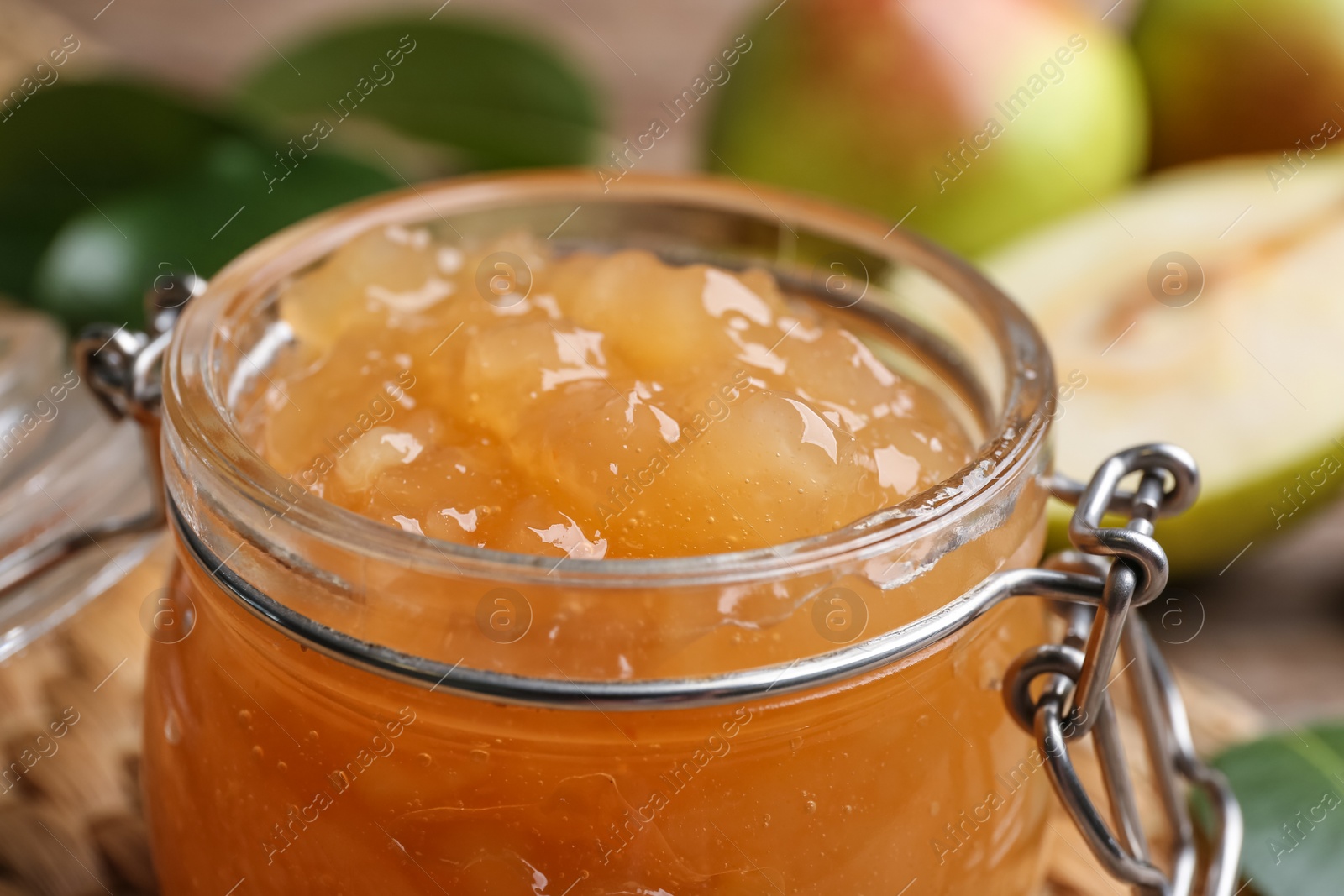 Photo of Delicious pear jam in glass jar, closeup