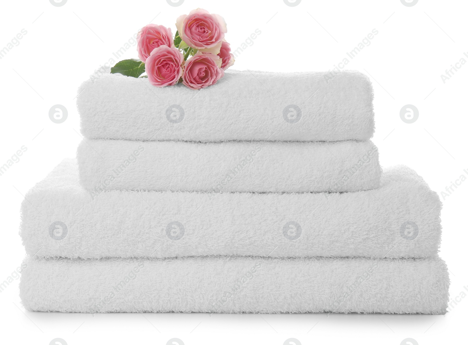 Photo of Fresh clean towels with roses on white background