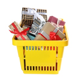 Shopping basket full of gift boxes on white background