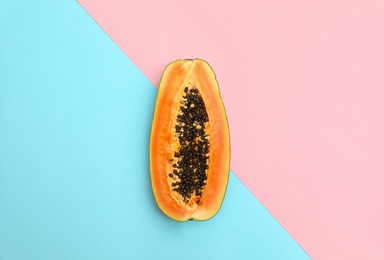 Fresh juicy halved papaya on color background, top view. Space for text