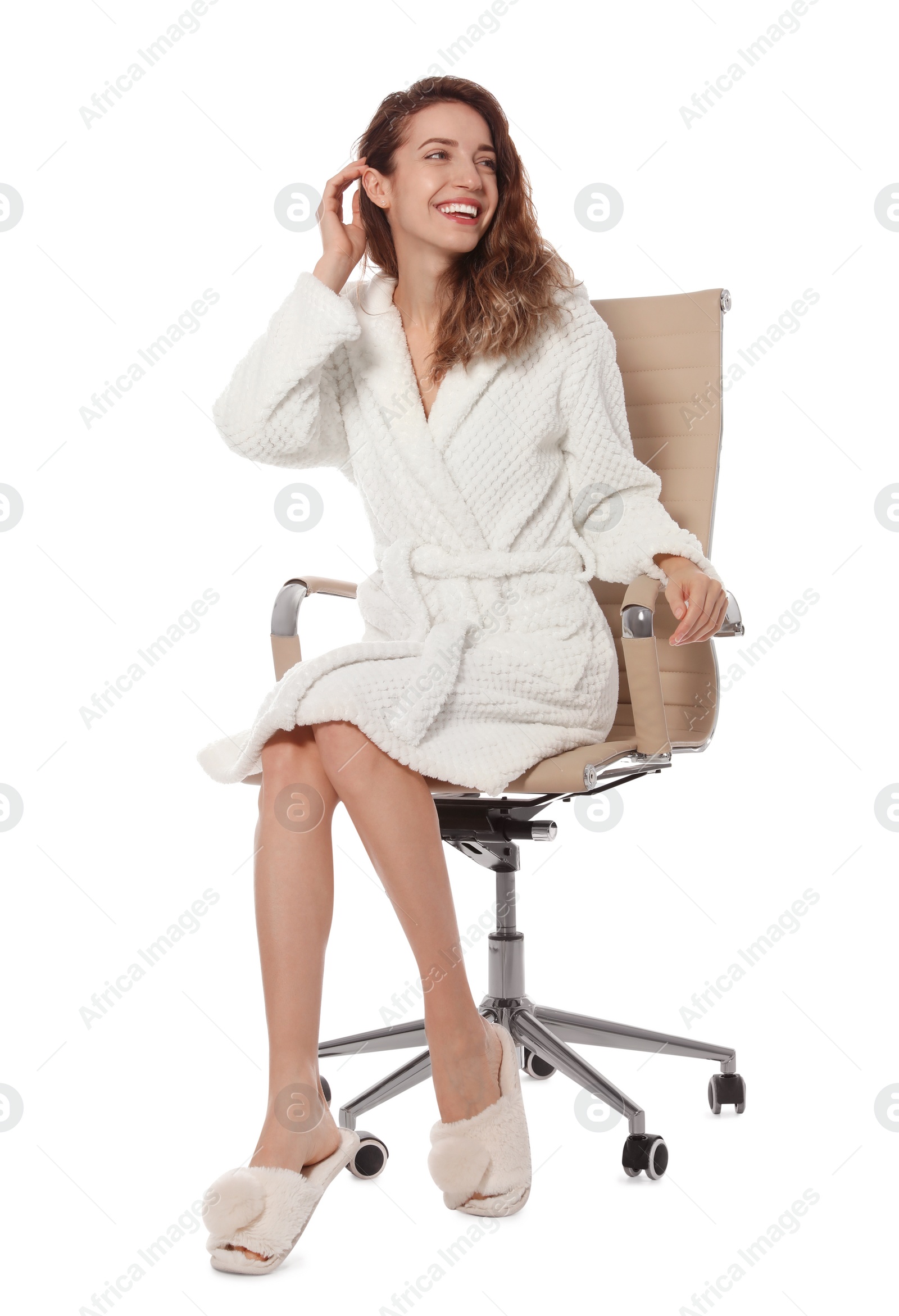 Photo of Beautiful young woman wearing bathrobe sitting in chair on white background