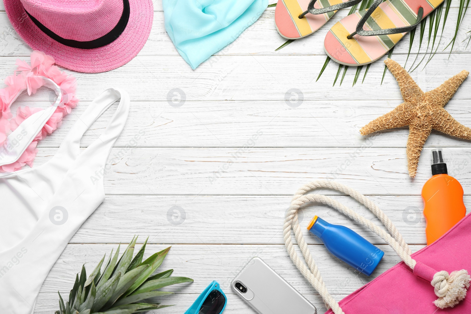 Photo of Flat lay composition with beach accessories on white wooden background, space for text