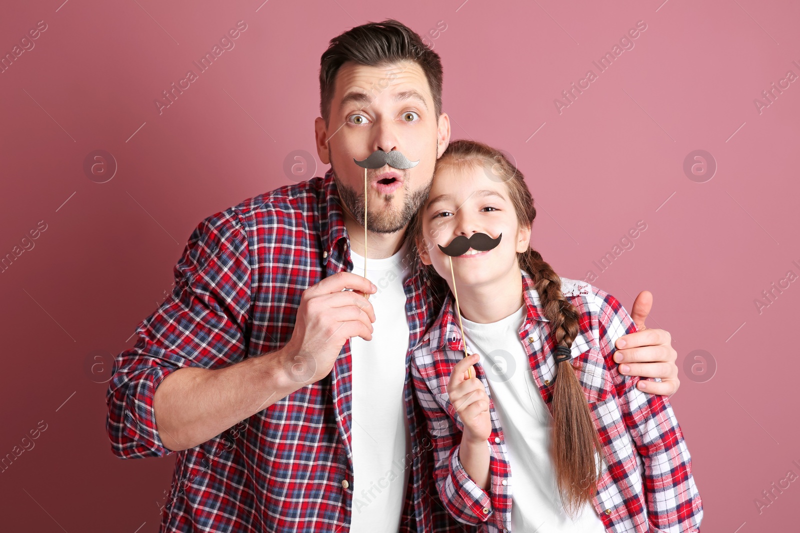 Photo of Dad and his daughter having fun on color background. Father's day celebration