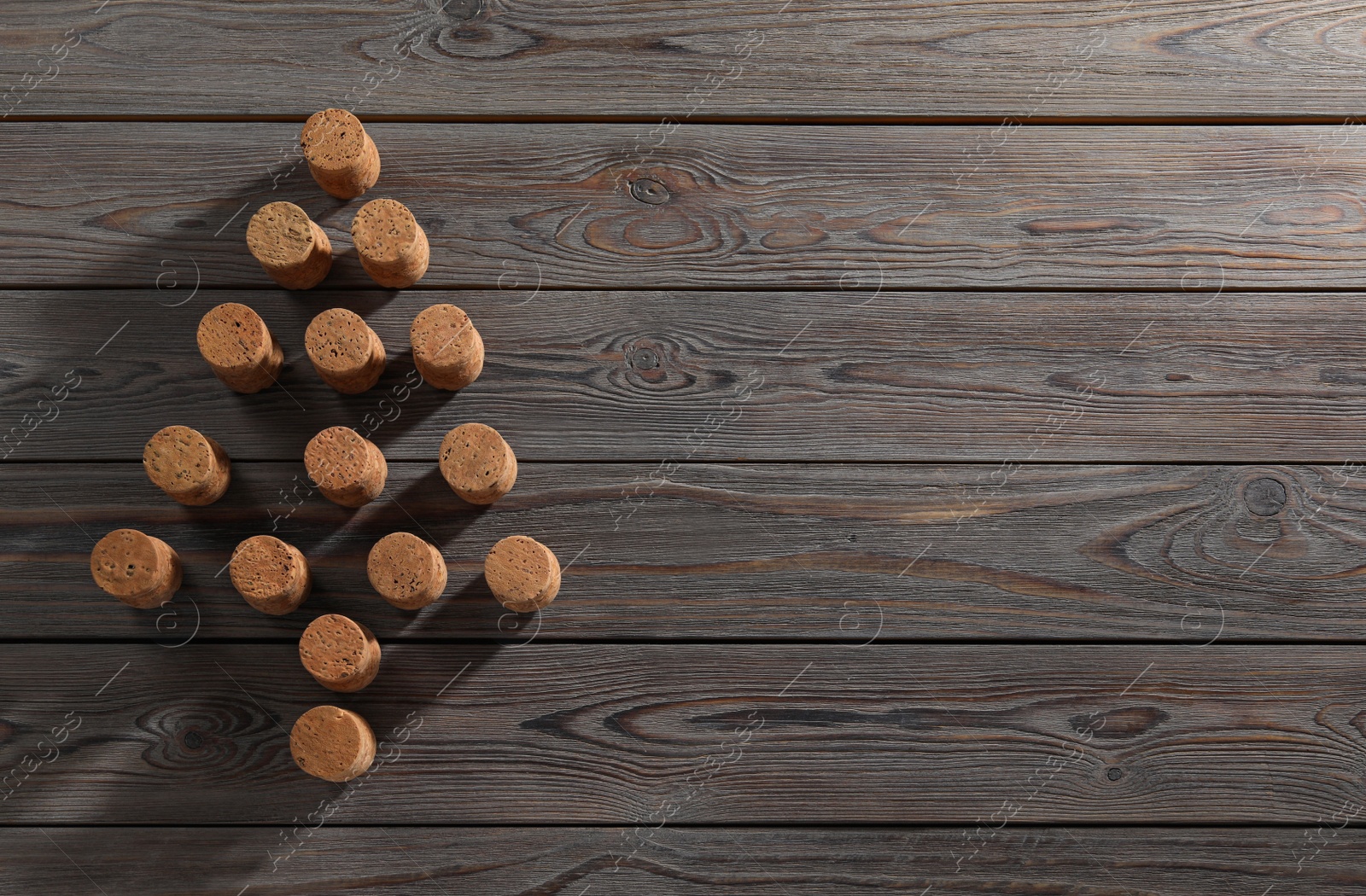 Photo of Christmas tree made of wine corks on wooden table, top view. Space for text