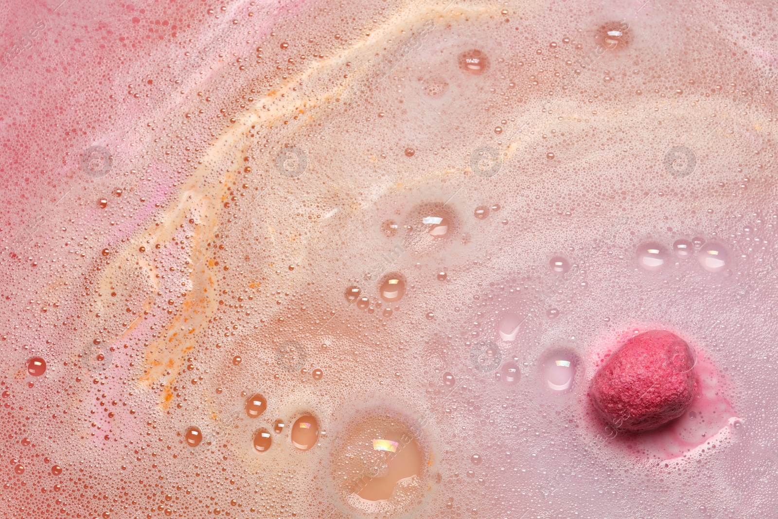 Photo of Beautiful pink bath bomb dissolving in water