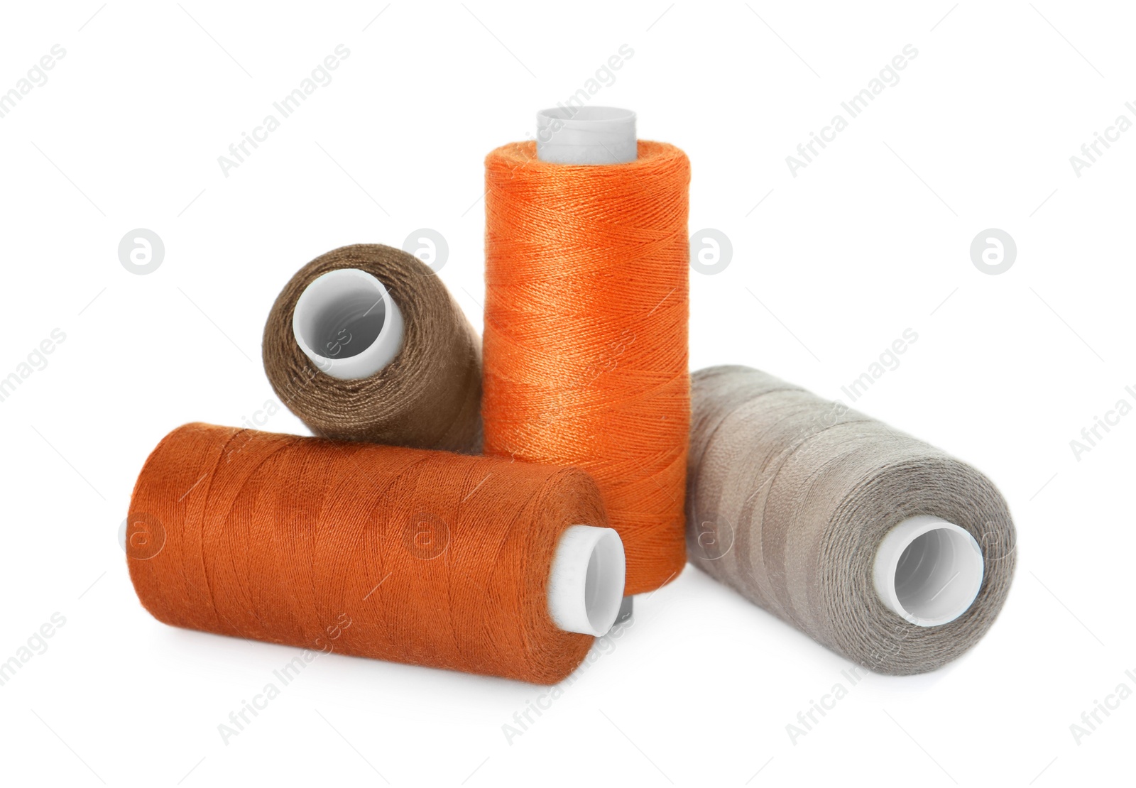 Photo of Many different colorful sewing threads on white background