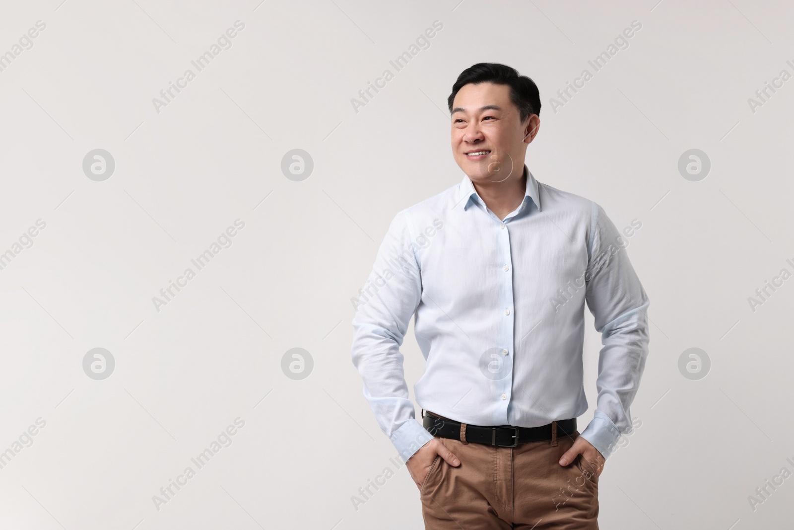 Photo of Portrait of happy man on light background. Space for text