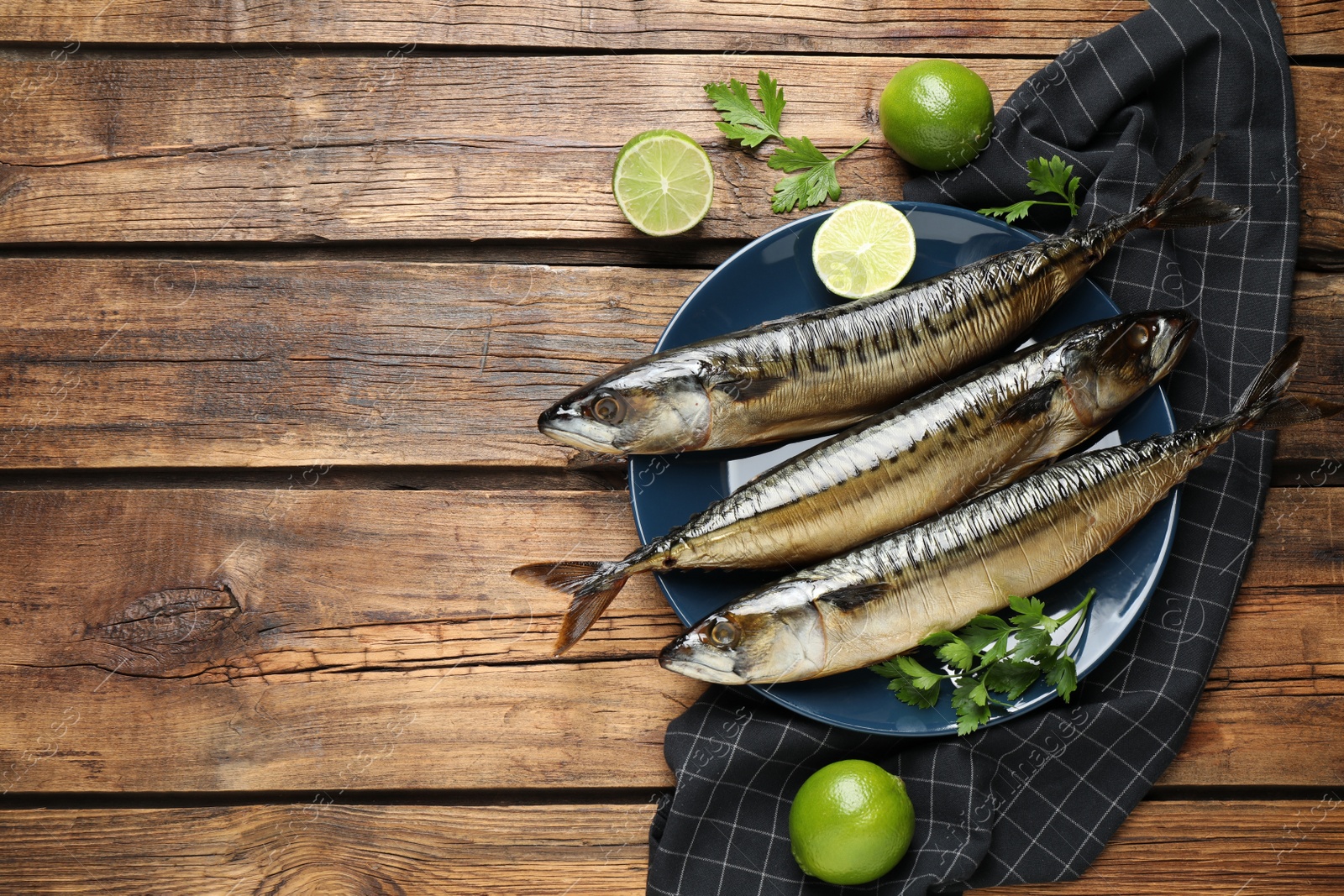 Photo of Tasty smoked fish on wooden table, flat lay. Space for text