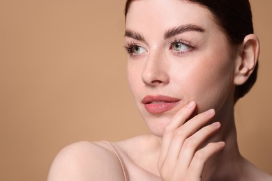 Photo of Portrait of beautiful woman on beige background, closeup