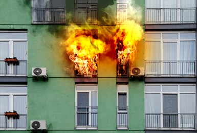 Image of Modern building engulfed in flames. Fire safety violations