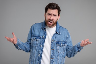 Photo of Portrait of surprised man on grey background