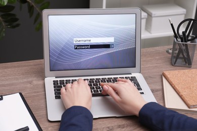 Photo of Woman unlocking laptop with blocked screen at wooden table indoors, closeup