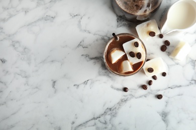 Composition with coffee drink and milk ice cubes on marble background, top view. Space for text