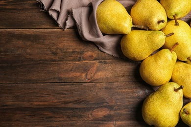 Photo of Flat lay composition with fresh ripe pears and space for text on wooden background