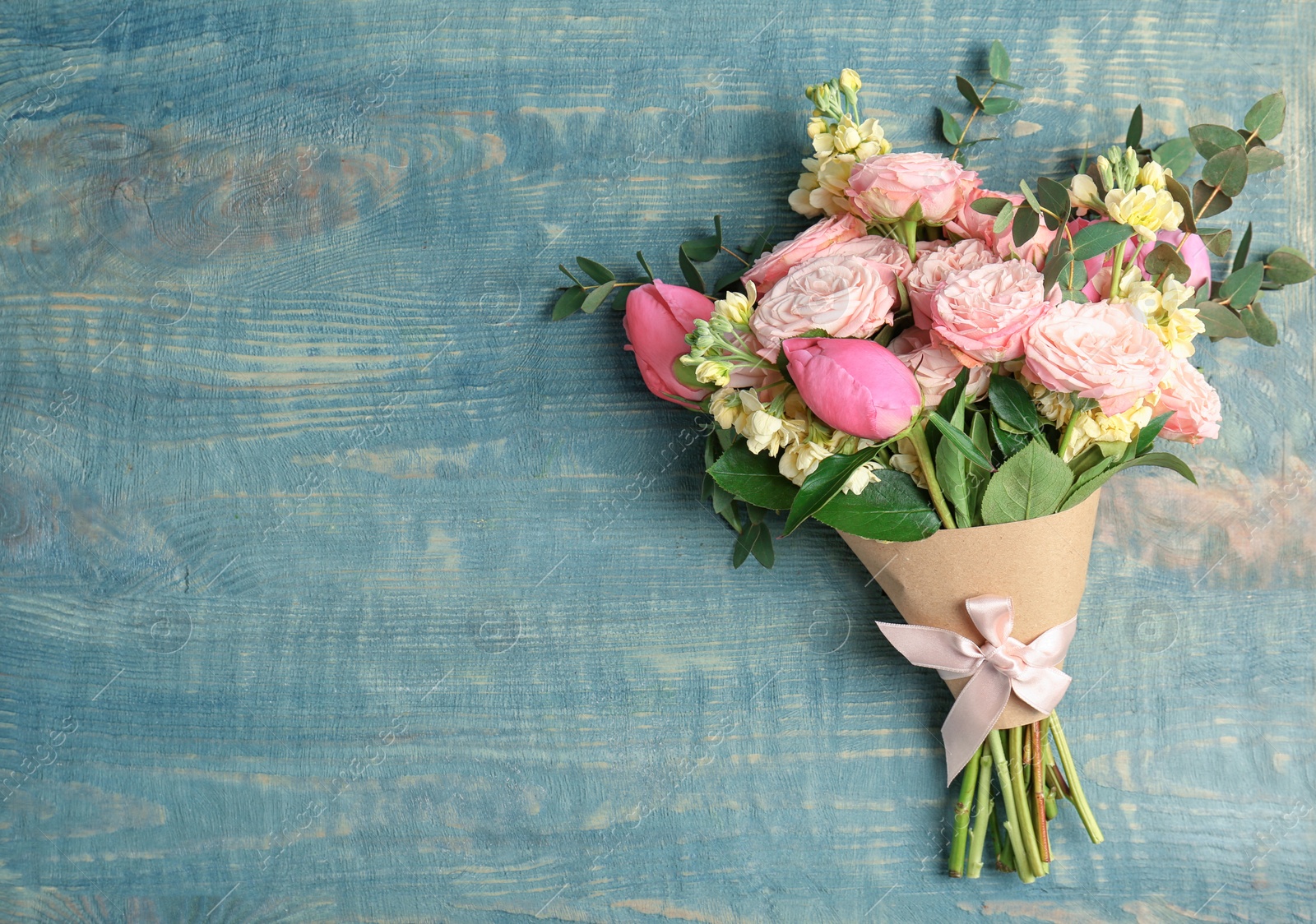 Photo of Bouquet of beautiful fragrant flowers on wooden background