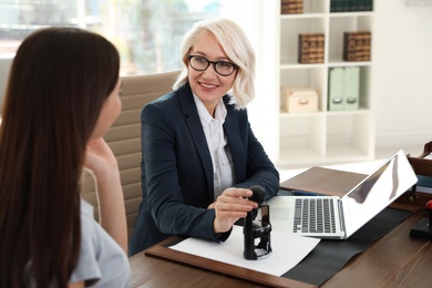 Photo of Female notary working with client in office