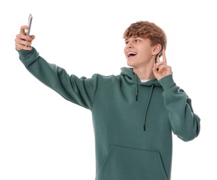 Photo of Teenage boy taking selfie on white background