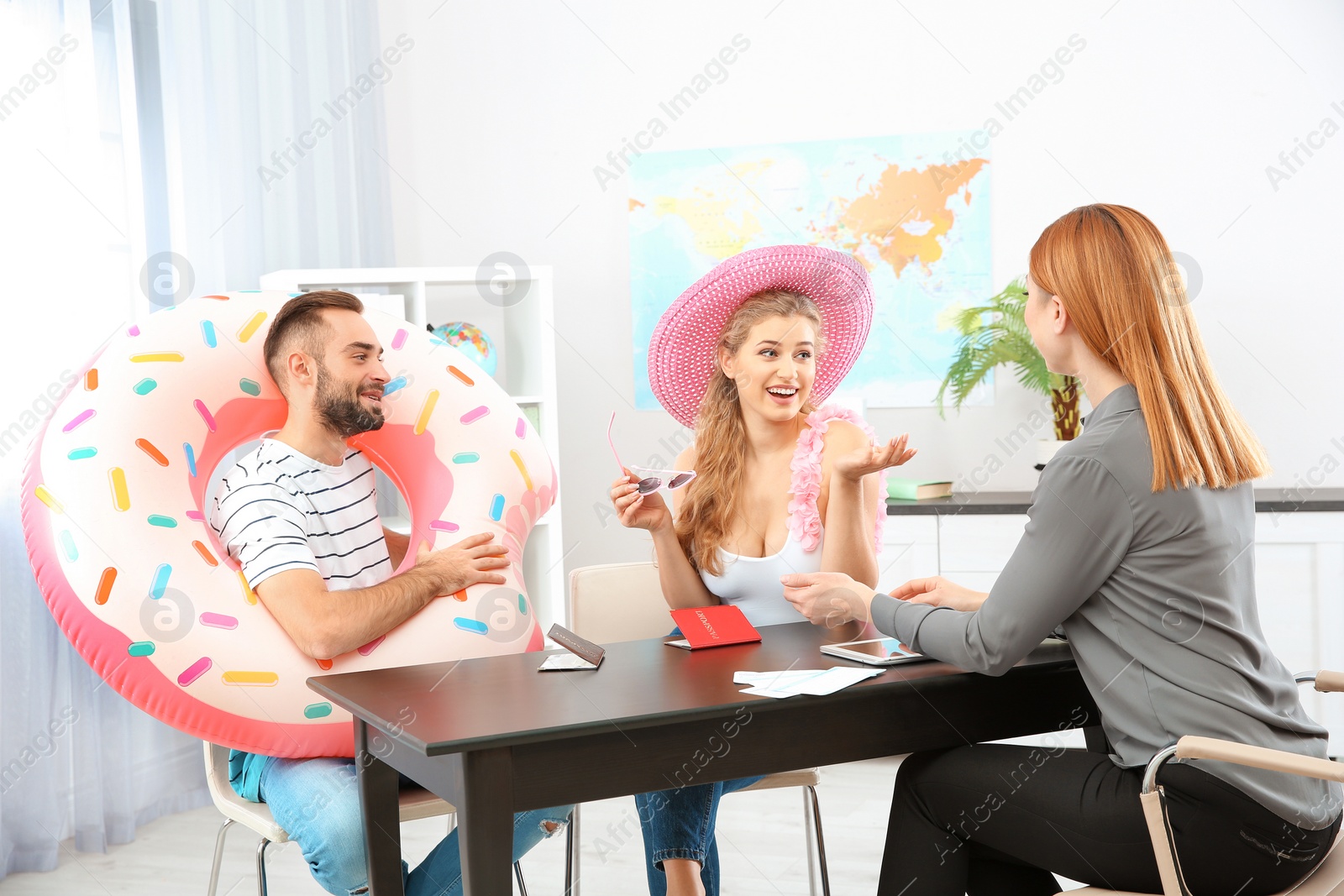 Photo of Beautiful young couple visiting travel agency office