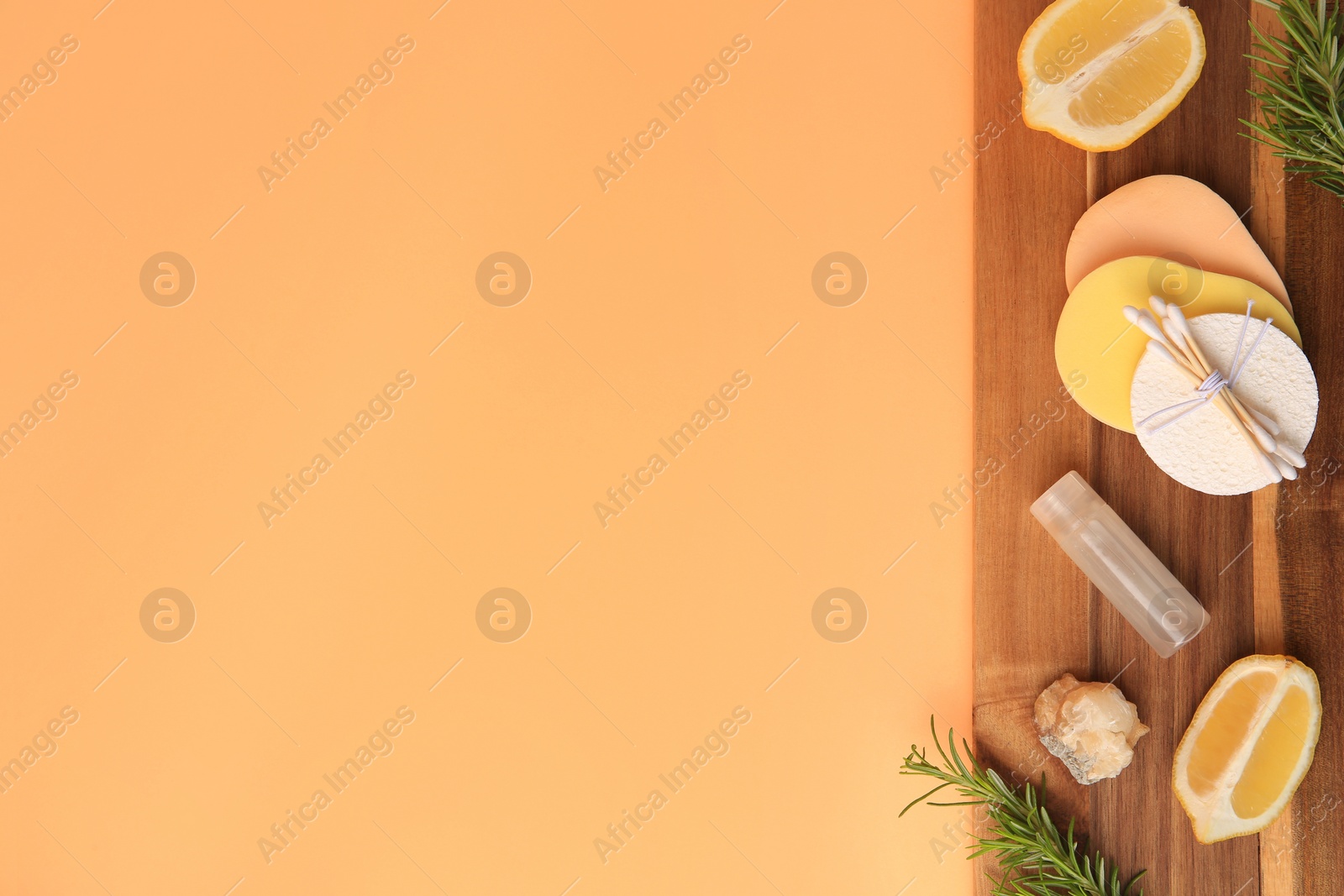 Photo of Lemon face cleanser. Fresh citrus fruits, rosemary and personal care products on pale orange background, top view with space for text