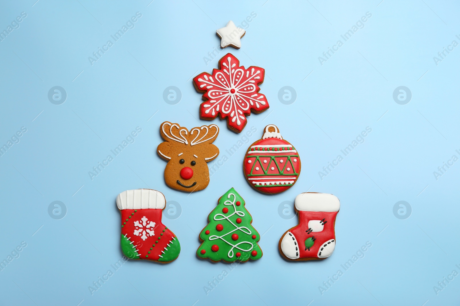 Photo of Different tasty Christmas cookies on light background, flat lay