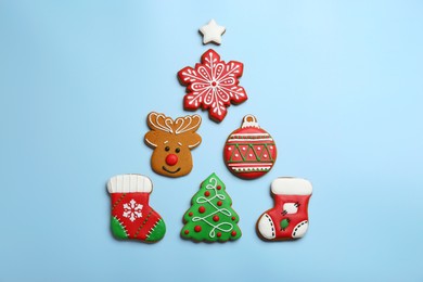Different tasty Christmas cookies on light background, flat lay