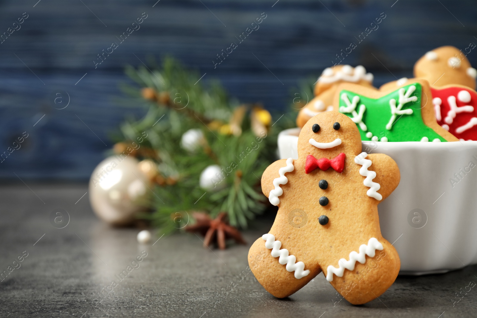 Photo of Tasty homemade Christmas cookies on grey table, closeup view. Space for text