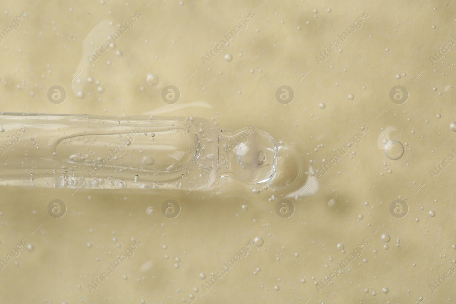Photo of Pipette with cosmetic serum on beige background, top view
