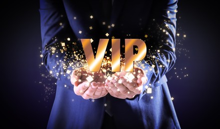 Image of VIP member. Closeup view of man showing virtual abbreviation on dark background