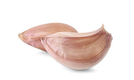 Photo of Fresh unpeeled garlic cloves on white background