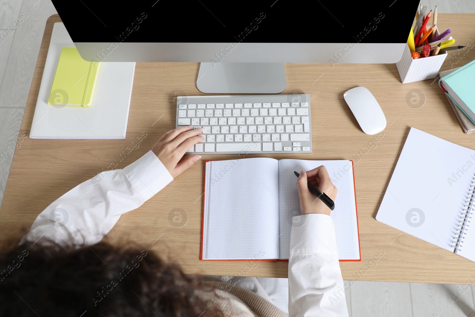 Photo of African American woman studying at table indoors, above view. Distance learning