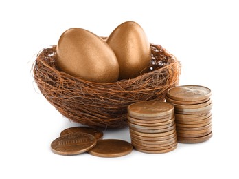 Photo of Two golden eggs in nest and coins on white background. Pension concept