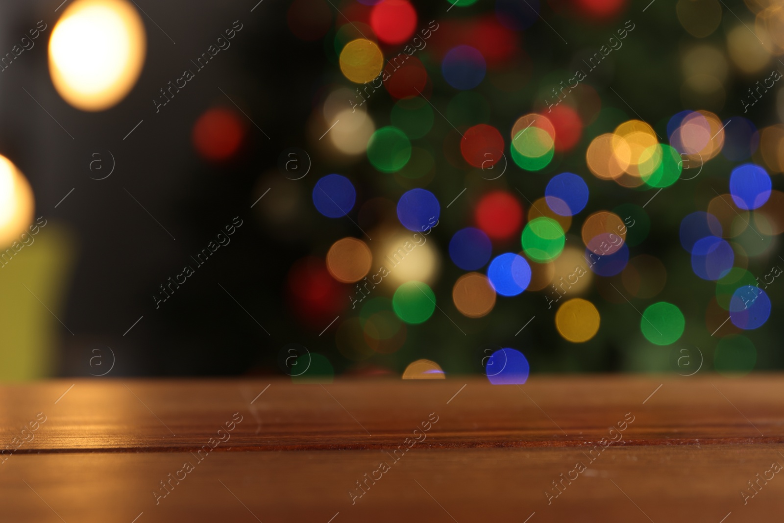 Photo of Empty wooden table against blurred festive lights