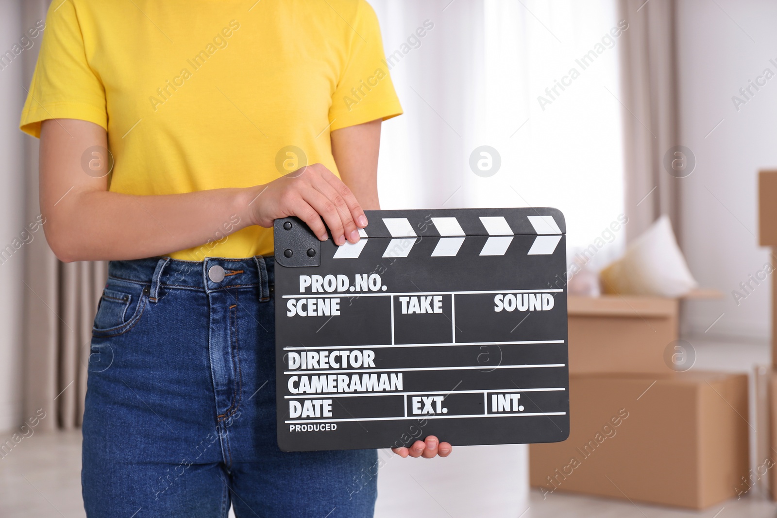 Photo of Operator holding clapperboard during the production indoors, closeup