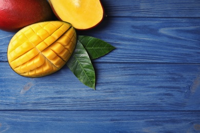 Photo of Flat lay composition with mango on wooden background. Space for text