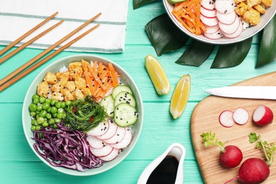 Photo of Delicious salad with chicken and vegetables on turquoise wooden table, flat lay